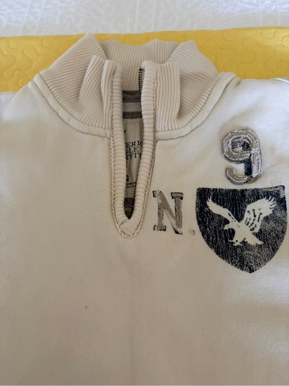 American Eagle Outfitters Cream V-Neck Pullover with Navy Emblem